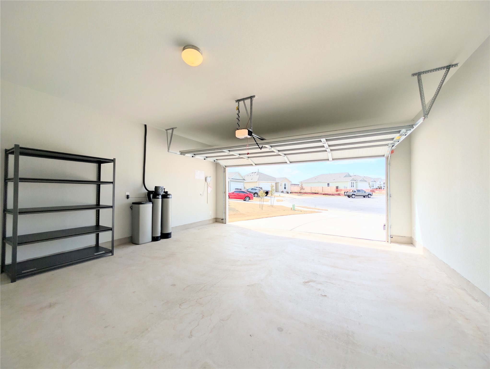 5524 Sacra Cove Austin, TX 78747 - Photo 25 of 37 Garage / water softener with a residential view
