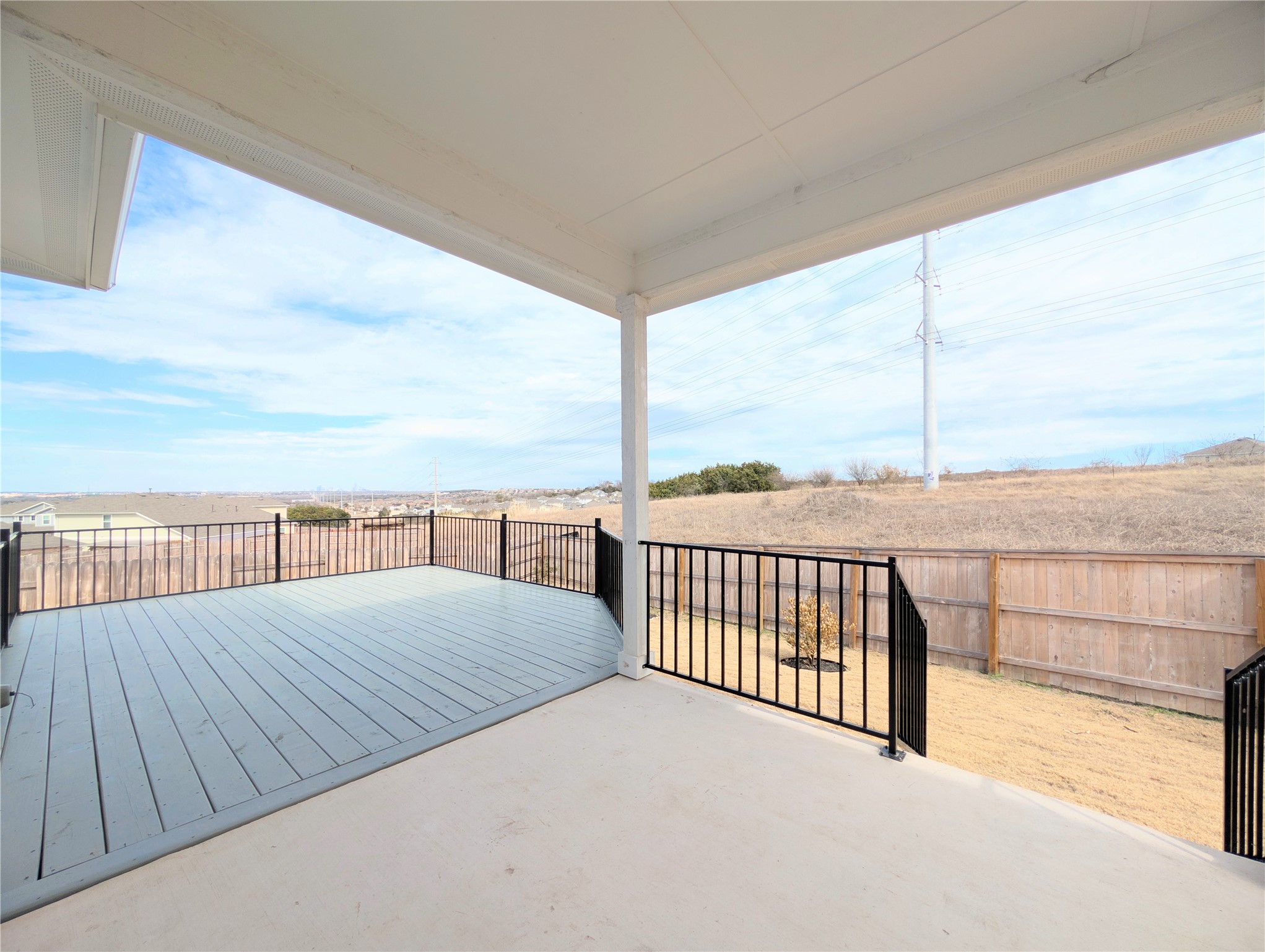 5524 Sacra Cove Austin, TX 78747 - Photo 27 of 37 Back patio with a custom built dark grey wooden deck with a skyline & private view