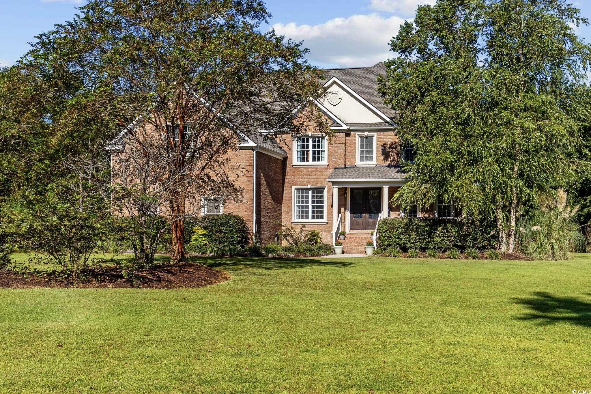 2273 Starduster Lane Little River, SC 29566 - Photo 40 of 40 View of front facade featuring a front lawn, covered porch, and brick siding