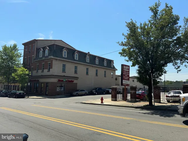 a view of a street that has a fountain and a tree