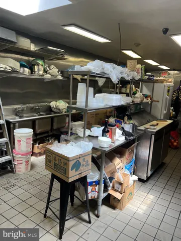 a room with stainless steel appliances kitchen island granite countertop furniture and a kitchen view