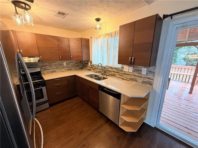 a kitchen with granite countertop a stove and a refrigerator
