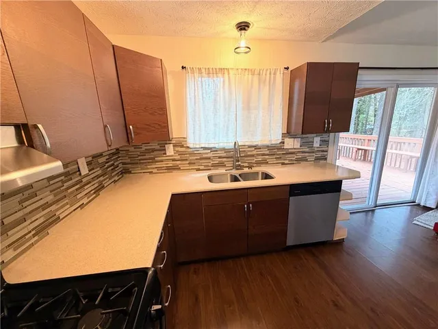 a kitchen with a sink stove and cabinets