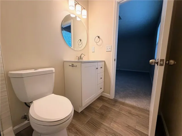 a bathroom with a sink a toilet a shower and a mirror