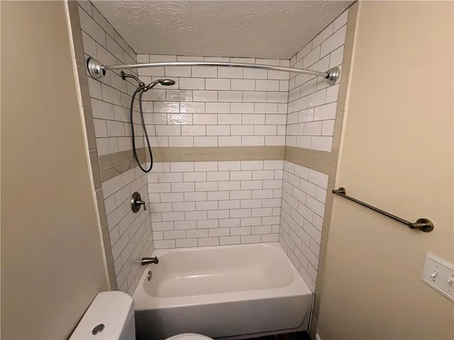 a view of a livingroom with a ceiling fan and window