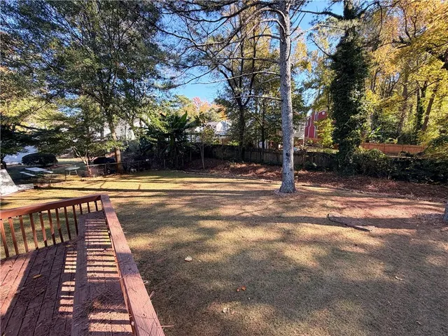 a view of a yard with large trees