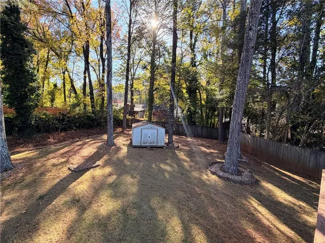 a view of a house with a patio and a yard