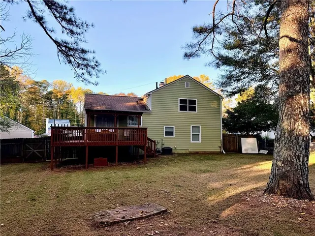a view of a backyard with large trees