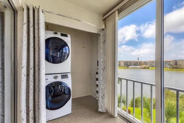 a view of a dining room with furniture a chandelier and wooden floor