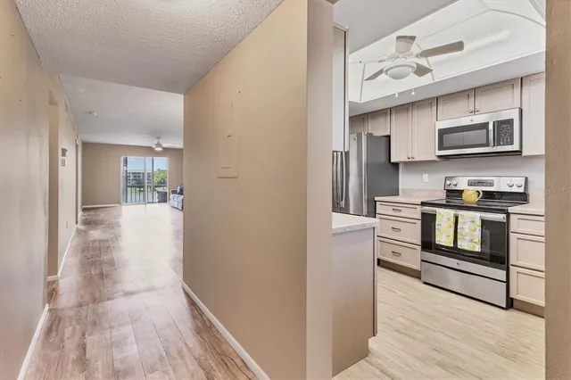 a kitchen with stainless steel appliances granite countertop a sink and cabinets