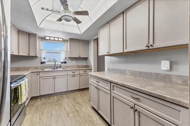a kitchen with granite countertop stainless steel appliances and wooden cabinets