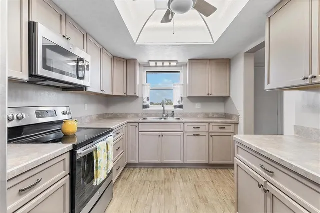 a kitchen with stainless steel appliances a stove microwave and a refrigerator