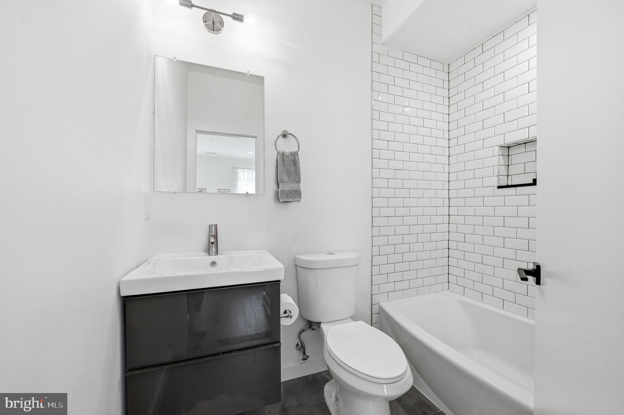 2604 Reed Street Philadelphia, PA 19146 - Photo 32 of 45 a bathroom with a sink toilet a mirror and shower