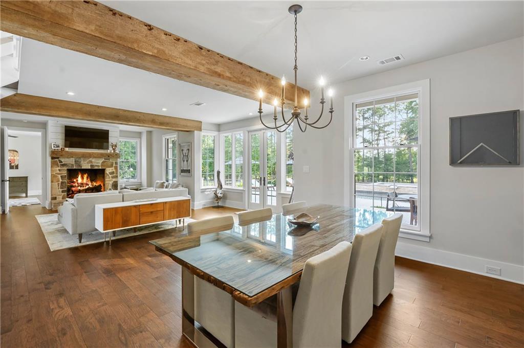 7255 Old Rico Road Chattahoochee Hills, GA 30268 - Photo 17 of 78 a dining room with furniture a chandelier and wooden floor