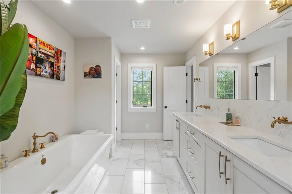 7255 Old Rico Road Chattahoochee Hills, GA 30268 - Photo 33 of 78 a bathroom with a tub sink and mirror
