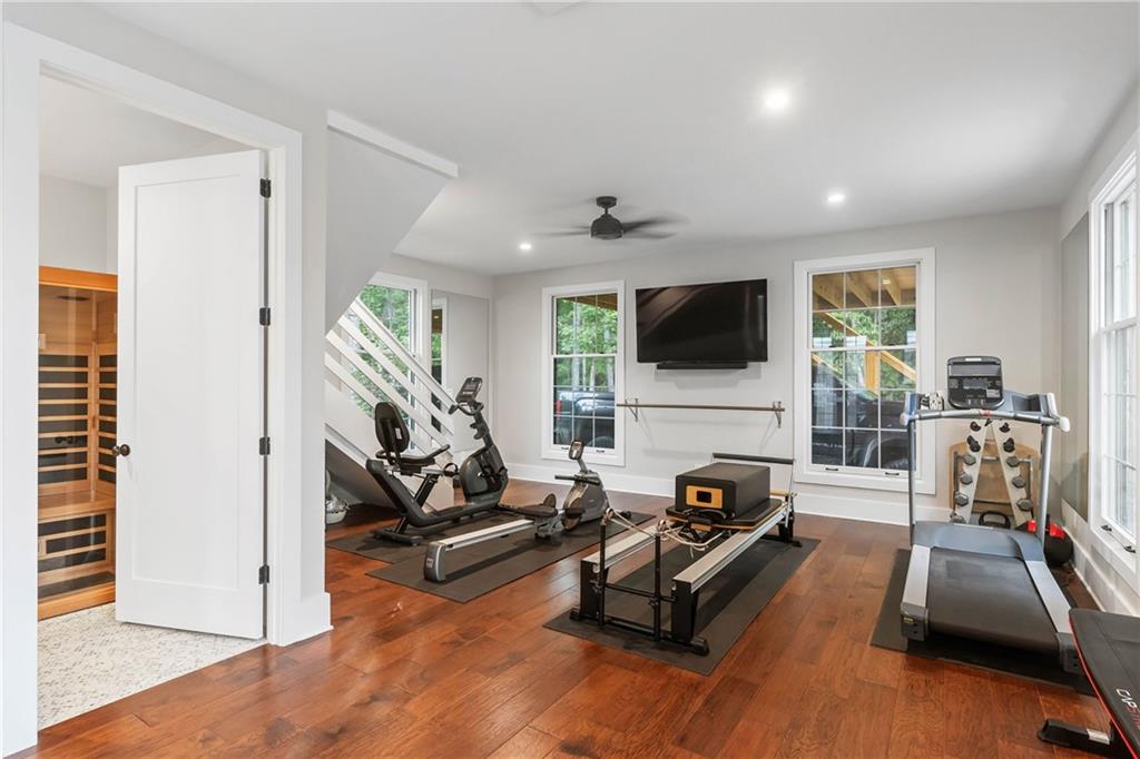 7255 Old Rico Road Chattahoochee Hills, GA 30268 - Photo 42 of 78 a living room with furniture gym equipment and a flat screen tv