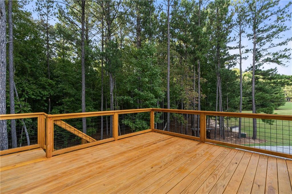 7255 Old Rico Road Chattahoochee Hills, GA 30268 - Photo 47 of 78 a view of a balcony with wooden floor and fence