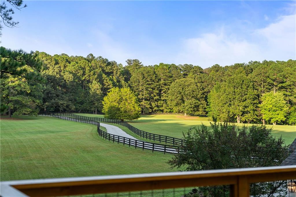 7255 Old Rico Road Chattahoochee Hills, GA 30268 - Photo 48 of 78 a view of a swimming pool and trees in the background