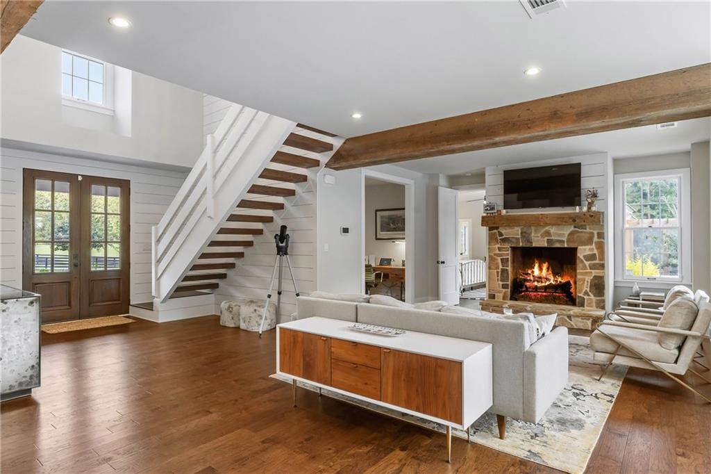 7255 Old Rico Road Chattahoochee Hills, GA 30268 - Photo 5 of 78 a living room with furniture a fireplace and a flat screen tv
