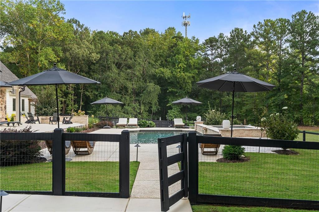 7255 Old Rico Road Chattahoochee Hills, GA 30268 - Photo 51 of 78 a view of a table and chairs under an umbrella