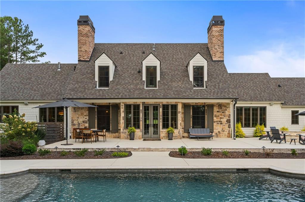 7255 Old Rico Road Chattahoochee Hills, GA 30268 - Photo 54 of 78 a front view of a house with a yard table and chairs