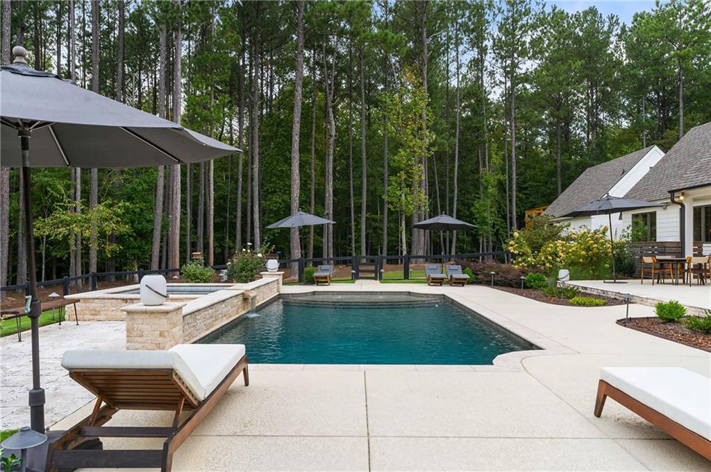 7255 Old Rico Road Chattahoochee Hills, GA 30268 - Photo 56 of 78 a view of a house with swimming pool and sitting area