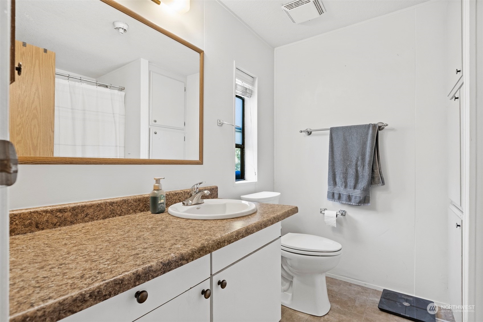 4859 Noon Road Bellingham, WA 98226 - Photo 34 of 40 a bathroom with a granite countertop sink and a mirror