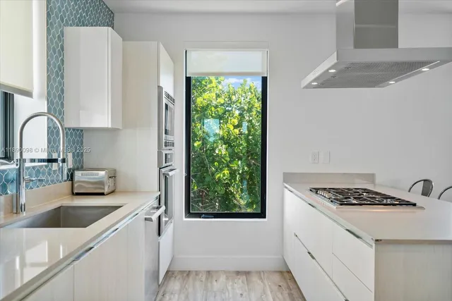 a kitchen with a sink and cabinets