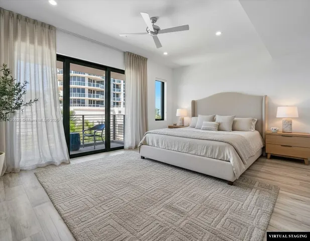 a bathroom with a tub a sink and a large mirror