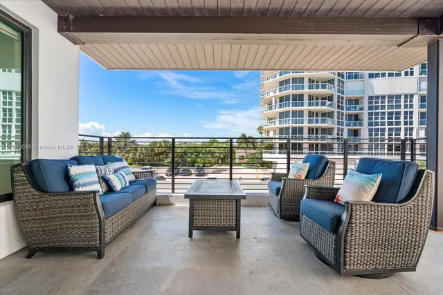 a view of balcony with wooden floor and seating space
