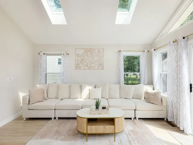 a living room with furniture and a large window