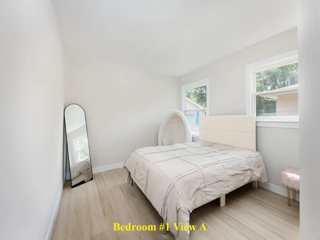 a bedroom with a bed and a window