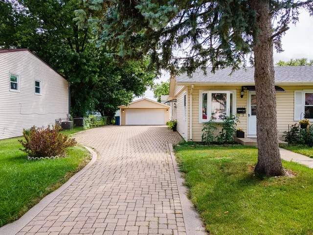 a front view of house with yard and green space