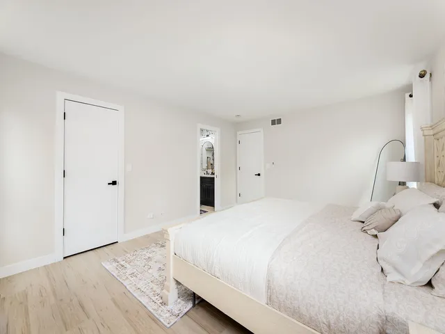 a bedroom with a bed and a dresser