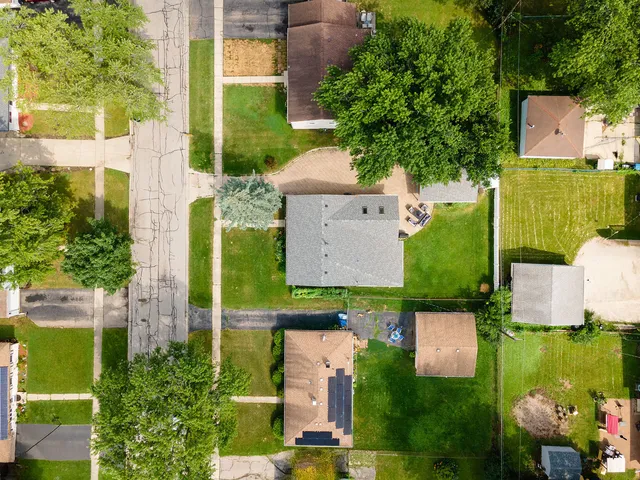an aerial view of a house with a yard pool patio and outdoor seating