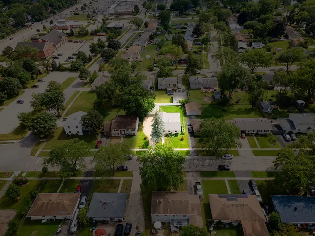 an aerial view of a houses with yard