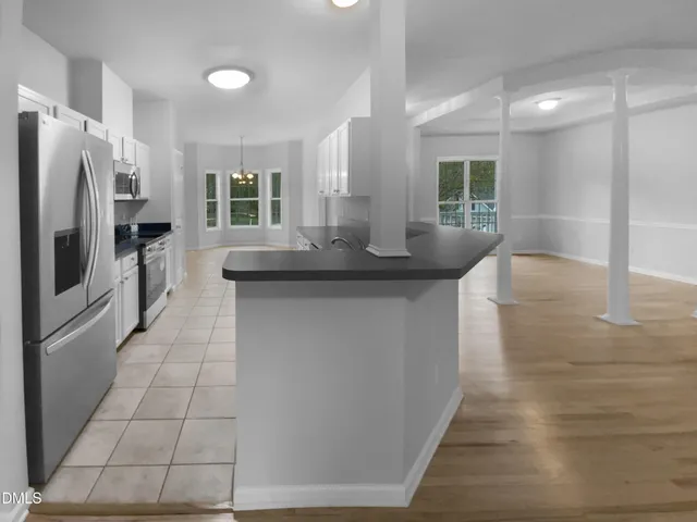 a kitchen with stainless steel appliances granite countertop a sink and a refrigerator