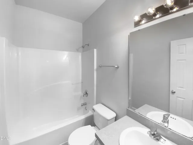 a bathroom with a toilet a sink and bathtub