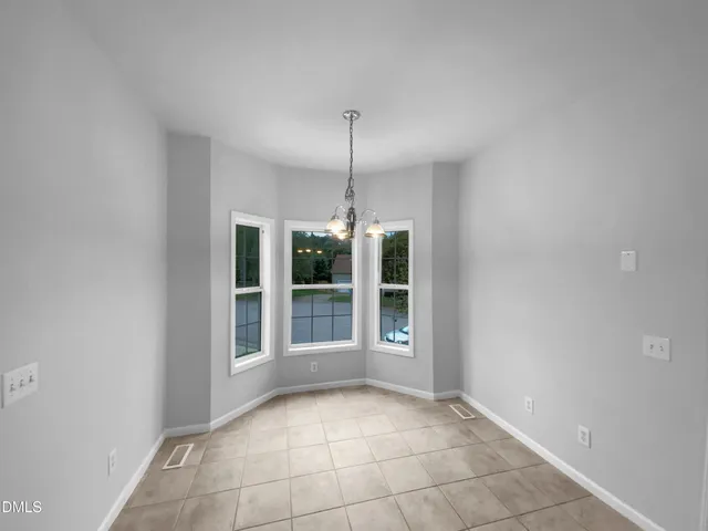 a view of an empty room with windows