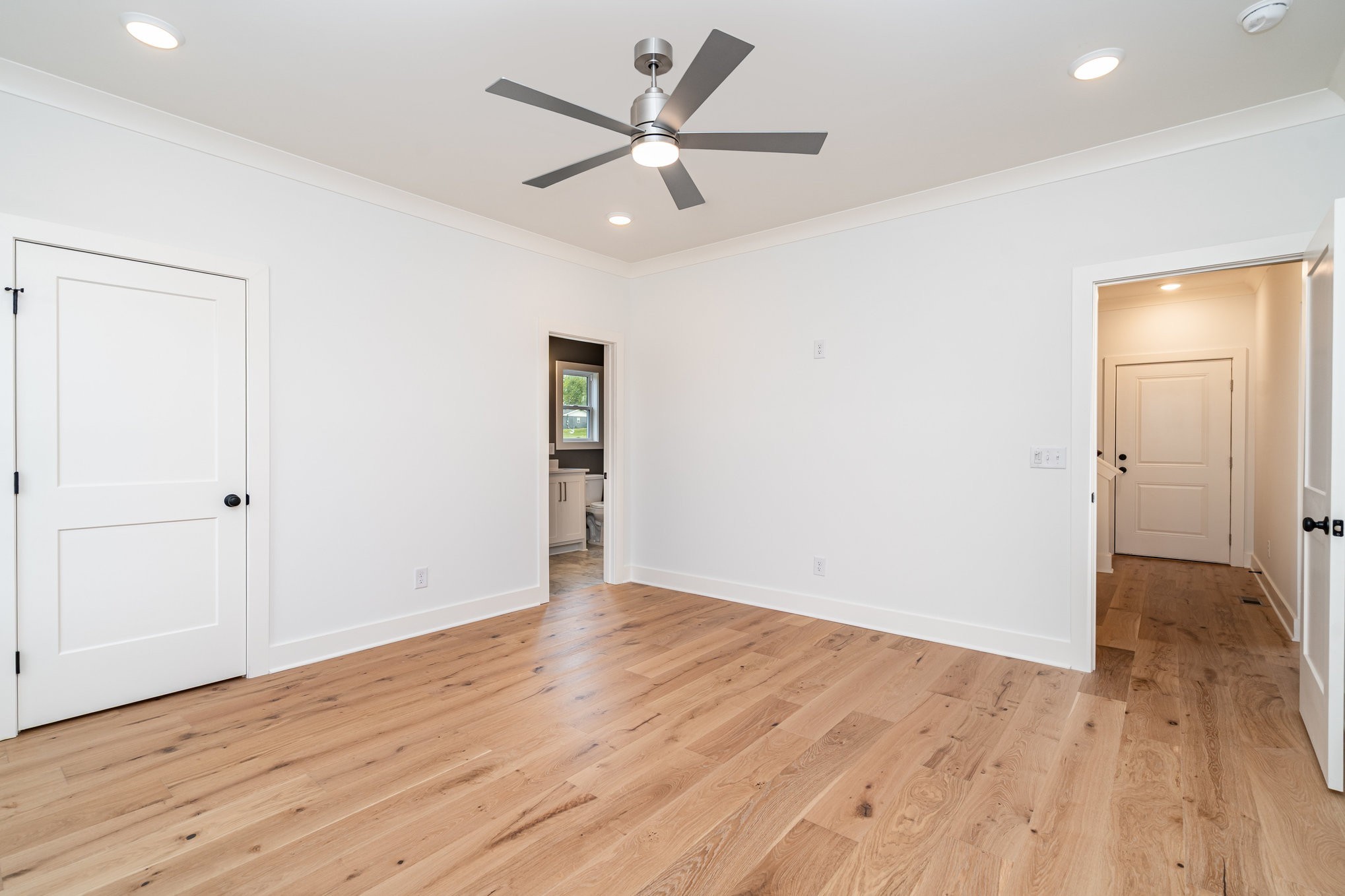 95 Crenshaw Road Hartsville, TN 37074 - Photo 12 of 31 an empty room with wooden floor and a ceiling fan