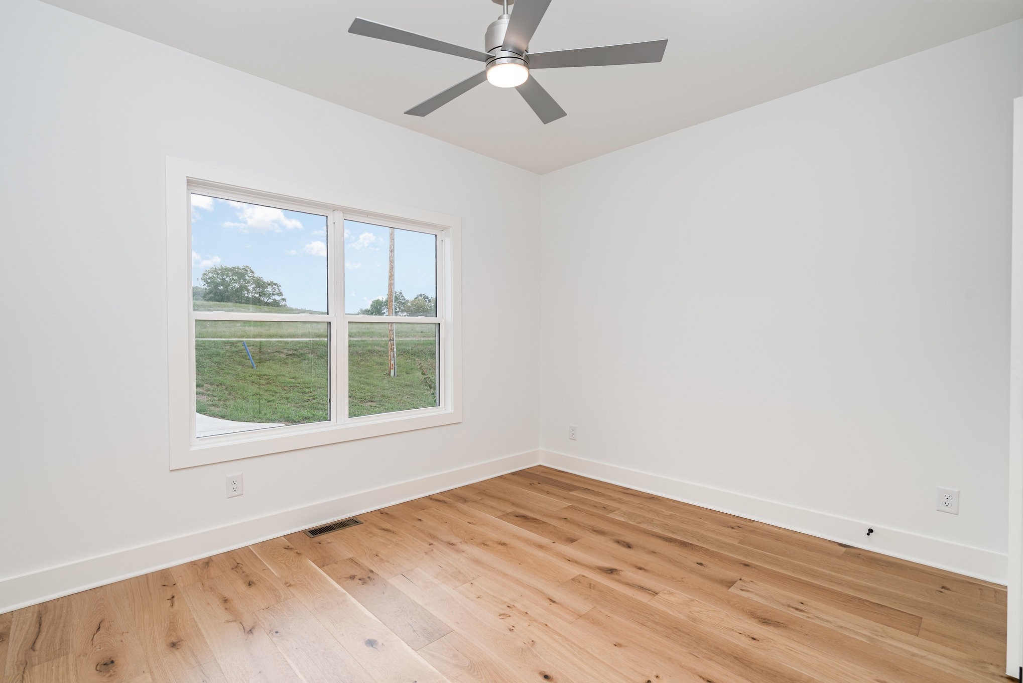 95 Crenshaw Road Hartsville, TN 37074 - Photo 16 of 31 an empty room with a window and wooden floor