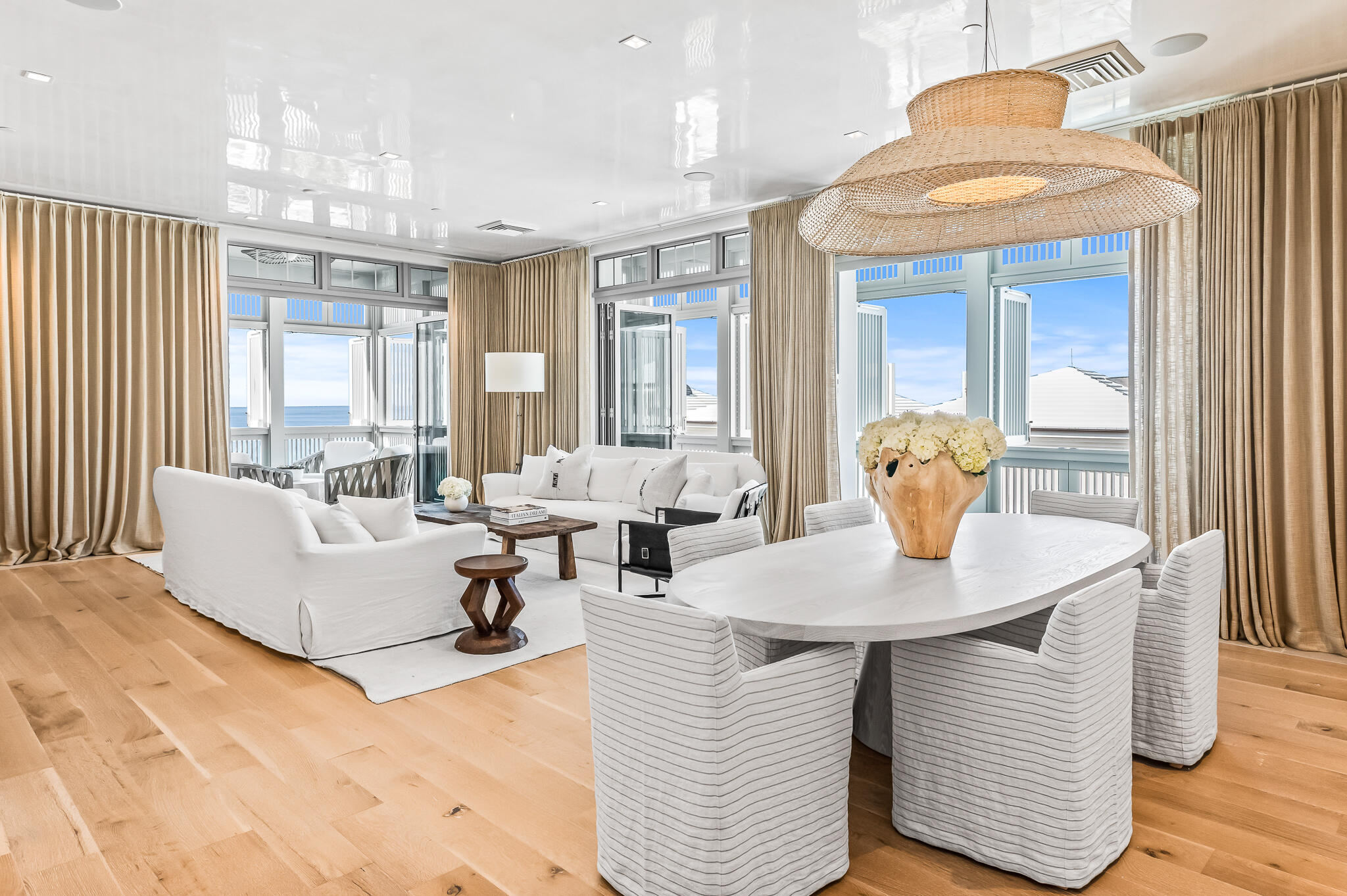 290 Sea Garden St Inlet Beach, Unit 402 Inlet Beach, FL 32461 - Photo 3 of 43 a living room with couches and a dining table with wooden floor