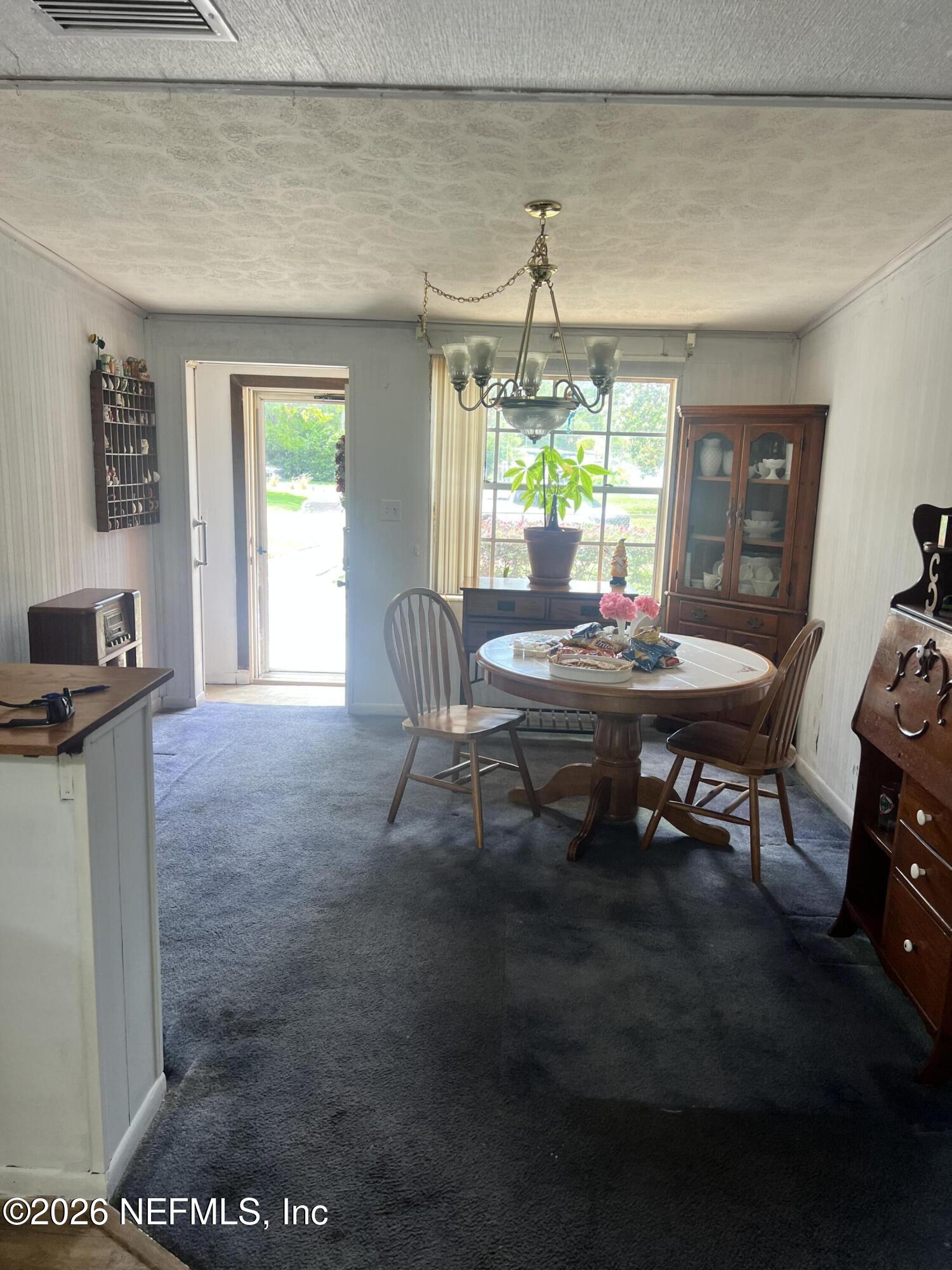 43 Forrestal Circle North Atlantic Beach, FL 32233 - Photo 7 of 39 a workspace with furniture and a chandelier