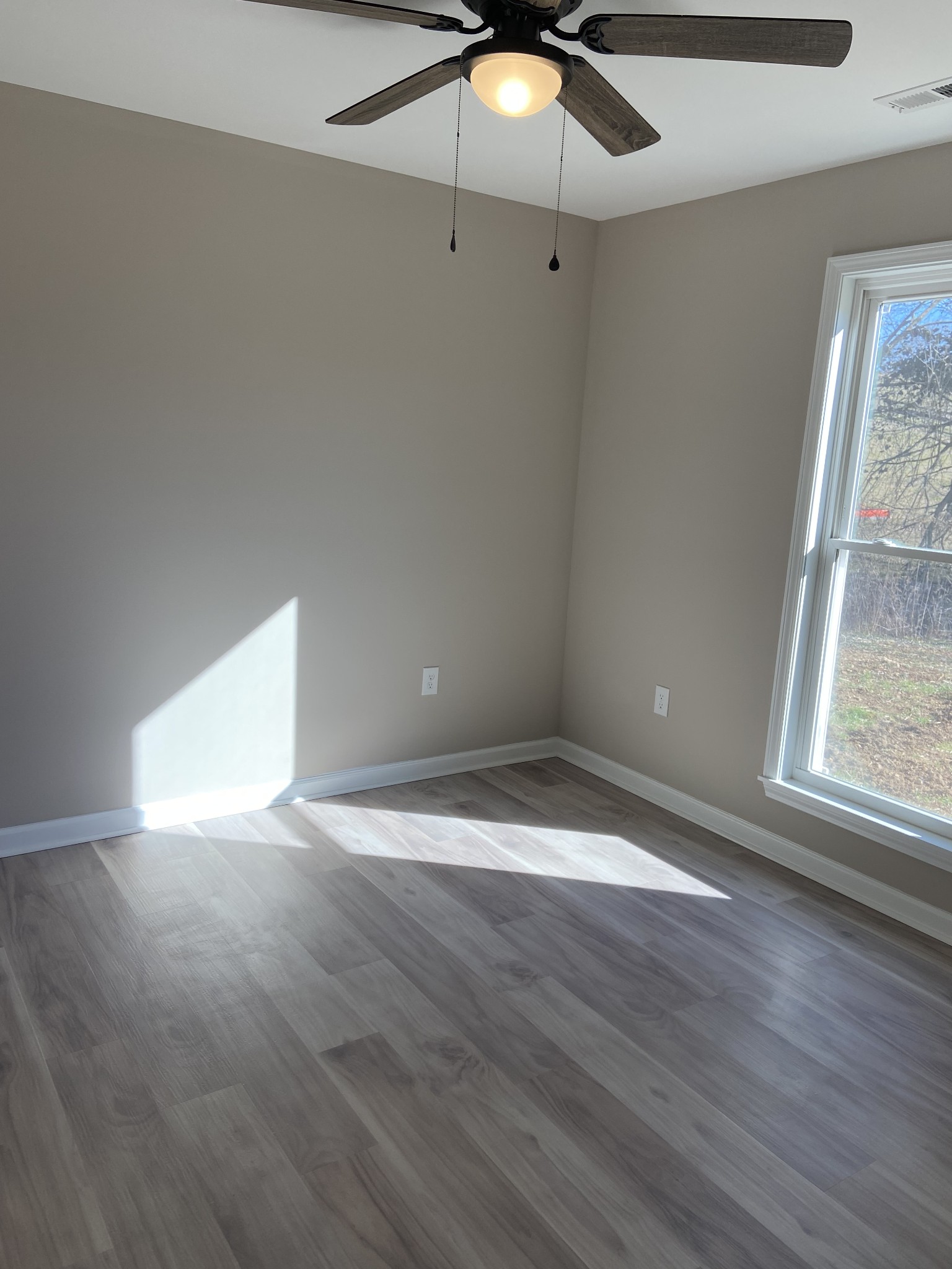 271 Chicken Creek Road Pulaski, TN 38478 - Photo 12 of 13 an empty room with wooden floor and windows
