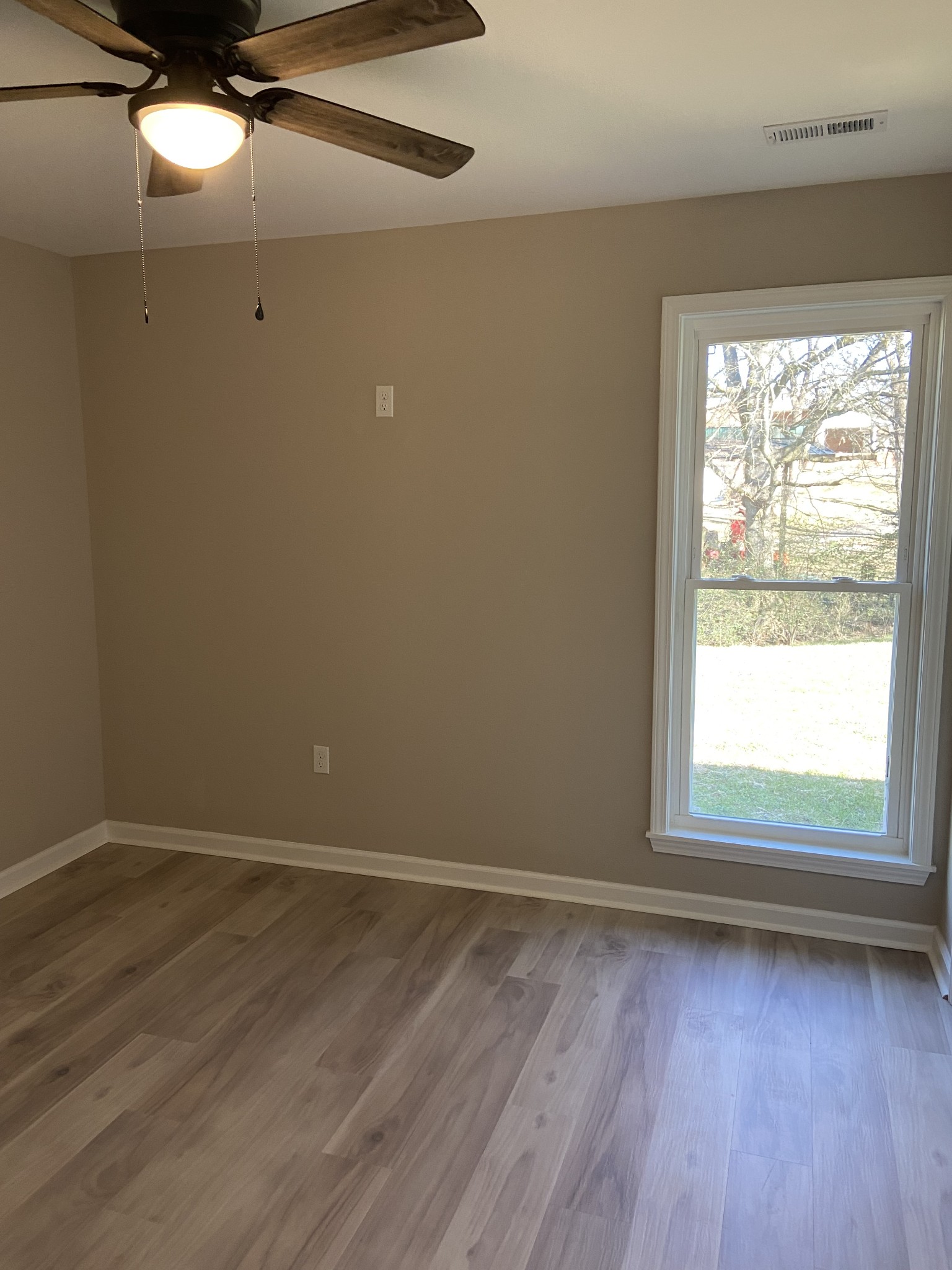 271 Chicken Creek Road Pulaski, TN 38478 - Photo 13 of 13 a view of an empty room with wooden floor and a window