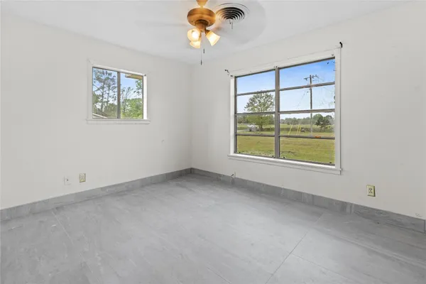 a view of a porch with furniture and floor to ceiling window