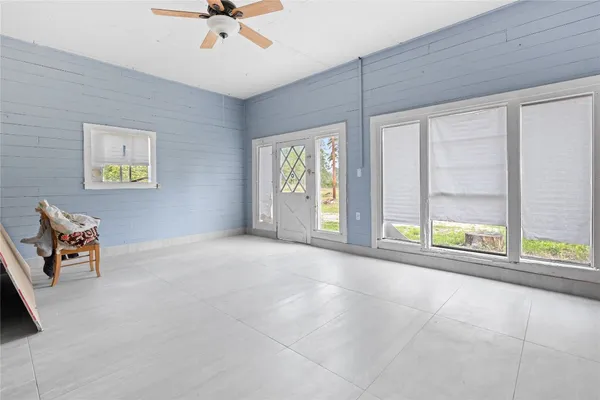 an aerial view of a residential houses with yard