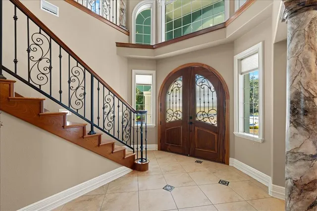 a living room with furniture and a chandelier