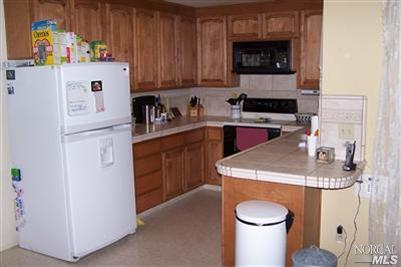 4813 Burlington Street Santa Rosa, CA 95405 - Photo 11 of 12 a kitchen with a sink a stove and cabinets