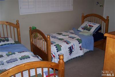 4813 Burlington Street Santa Rosa, CA 95405 - Photo 5 of 12 a bedroom with bed and a window